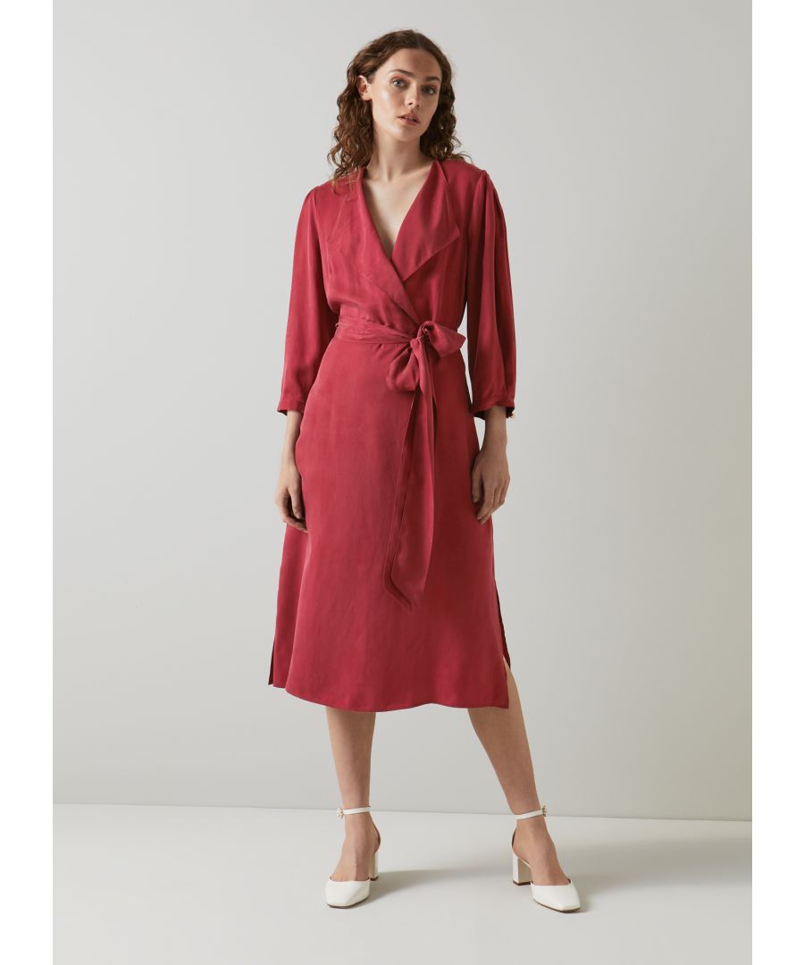 The Iris midi dress is crafted from cupro in red dahlia, It has an open-collar neckline, three-quarter sleeves, a tie waist belt and a floaty wrap skirt with side slit detail.