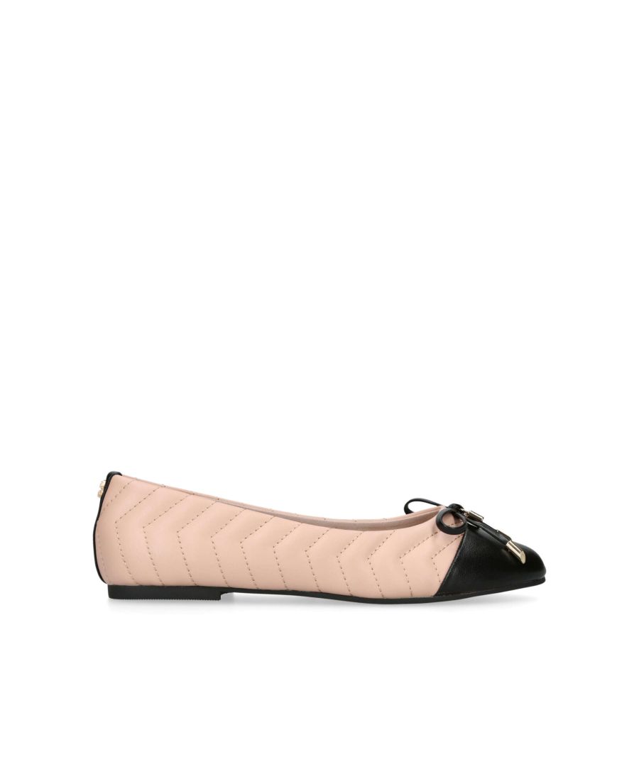 The Lily Ballerina flat shoe features a blush exterior with overstitch chevron quilt. The toe is in black with gold padlock charm on the bow. The back of the ankle features a micro gold tone Icon C.
