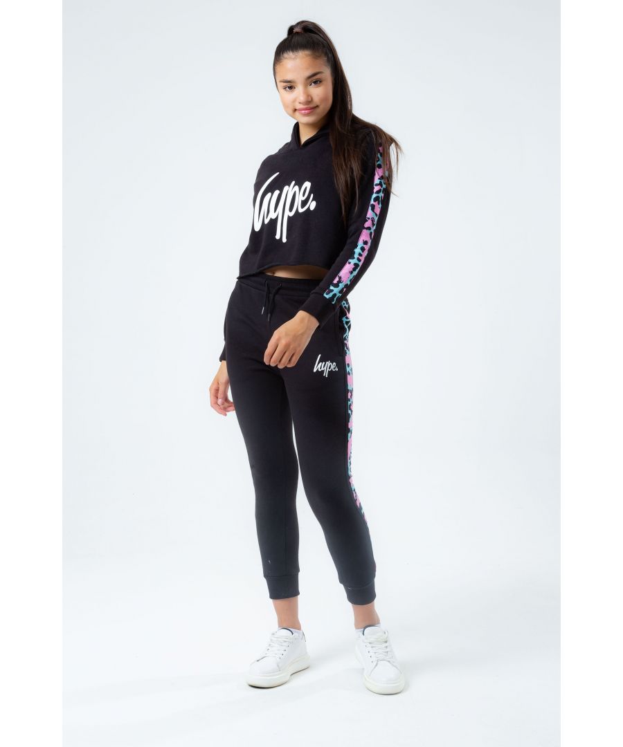 Junior Girls Hype Leopard Panel Tracksuit in black. - Sweatshirt:- Lined hood.- Ribbed cuffs and hem.- Animal inspired print on the sleeves.- The iconic hype logo in white.- 70% Cotton  30% Polyester. Machine washable.- Pants:- Drawstring waist.- Ribbed cuffs.- Two front pockets. - The iconic hype logo in white.- Regular fit.- 70% Cotton  30% Polyester. Machine washable.- Ref: GA005J