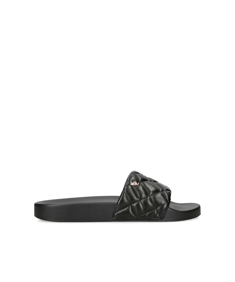 The Brixton Slide is a slip on sandal in black. The strap has a pillow effect with overstitch quilting detail and a small, gold tone KGL stud.