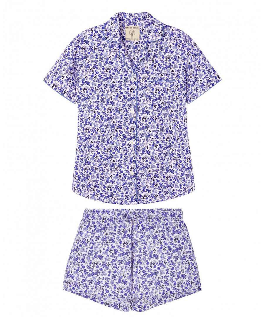 The blue rosy posy short pyjamas are created for warmer days using our beautifully fresh cotton. Designed in a pretty blue rose print, the pjs are finished with a traditional short sleeved jacket with rounded collar, curved hem and a handy breast pocket and the shorts have a tie waist. They are then piped to perfection in cornflower blue around the collar, along the pocket, and at the sleeve edge. If unsure about the sizing then we recommend that you round up and drawstring them in to fit. Because they are for lounging and wearing to bed we think they're more comfortable when worn loosely. So if you're a 10-12 buy the medium (12) and so on. They look great teamed with the matching robe too. All that's left to do is to pull them on and relax in luxury.  available in sizes petite - xxl.  also available in matching mid-length robe, sleep shorts and long sleeve/leg pyjamas.  jacket length: 28