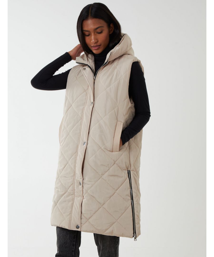 If you are need of a lighter layer for chilly days, our Diamond Quilted Longline Vest is ideal for you. With a mid length and a hoodie, layer this vest over a warm sweater for a quick, stylish look without adding bulk. \n100% polyester 