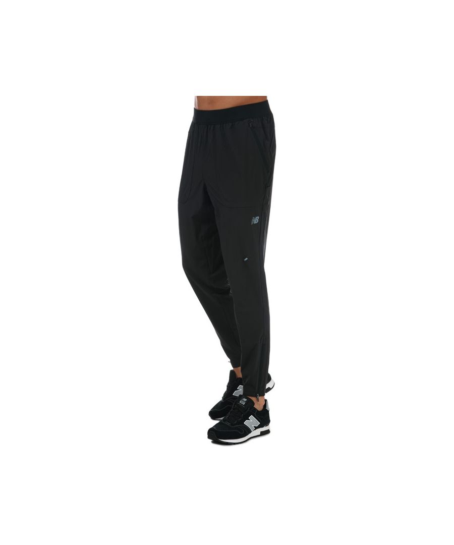 Mens New Balance Q Speed Crew Track Pants in black.- Cargo pockets and a secure zipper.- DWR four-way stretch woven fabric.- Zipper at bottom hem.- Reflective NB logo.- Athletic fit.- Shell1: 86% Polyester  14% Elastane. Shell2: 77% Polyester  23% Elastane. Machine washable. - Ref: MP93258BK