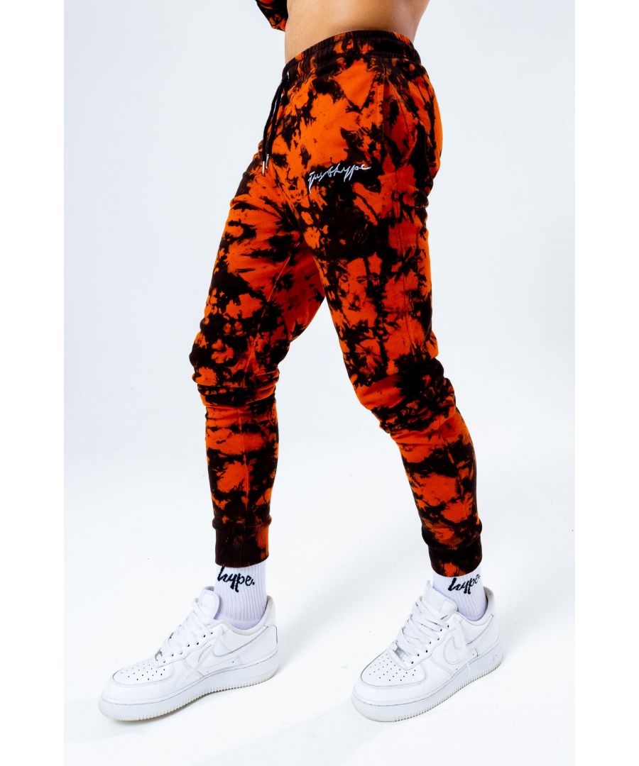 The HYPE. black orange tie dye men's joggers feature a black and orange colour palette. Stay on trend and grab the matching hoodie to complete the set. Designed in a soft-touch 100% cotton fabric base with the supreme amount of comfort you need from your new joggers. The design boasts an acidic tie-dye wash finished with an elasticated waistband, drawstring pullers and fitted cuffs. Finished with the new! just hype scribble logo. Machine wash at 30 degrees.