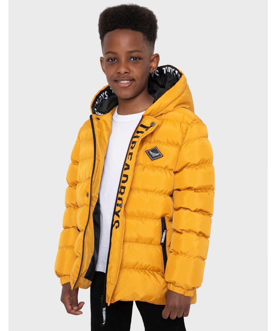 This hooded padded jacket from Threadboys features a popper fastening storm guard and concealing the zip. It also has elasticated cuffs, two side pockets and branding badge on the chest. The perfect back to school jacket, other colours also available.