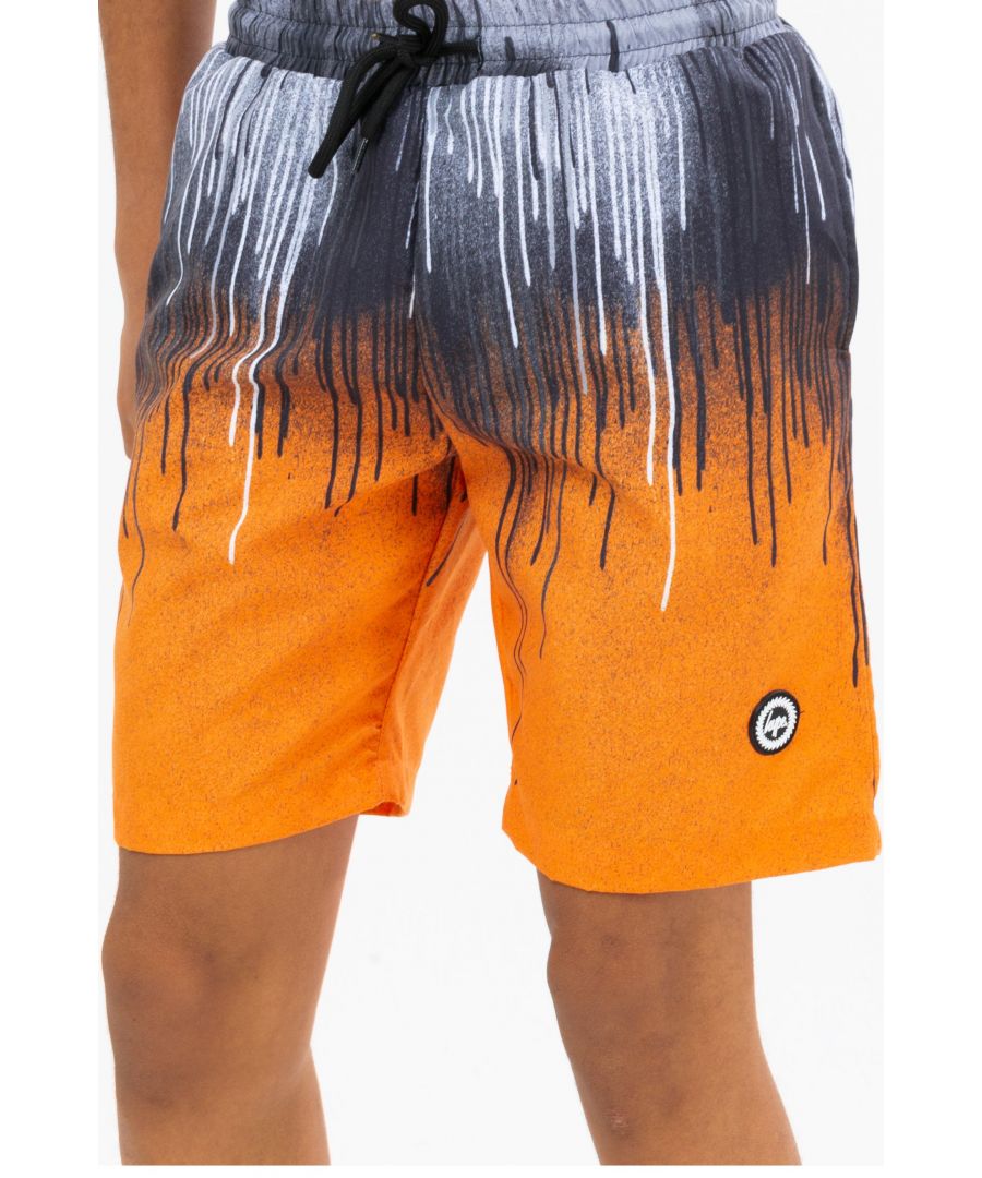 Stay cool by the pool this summer with the HYPE. Orange Drips Crest Swim Shorts. Designed in our swimming short shape with quick-drying poly fabric, a mesh inner layer, and an elasticated waistband for a custom feel. Boasting an all-over drip print in an orange, black and white colour palette and featuring our rubberised HYPE. crest. 