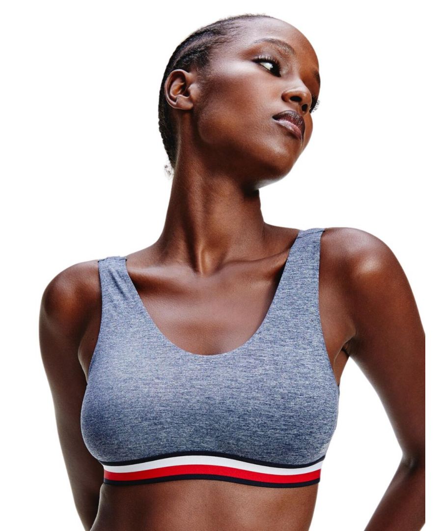 The colourful underband and super-soft fabrics make this Tommy Hilfiger bralette ultra comfortable and chic, for great everyday wear. This bralette is non-wired or padded for a natural fit and shape to your bust but offers full coverage with a scoop neckline to keep that support. The underband is also elasticated to offer the bust extra support. Wide straps and a low back with no complicated fastenings add to the comfort of this bralette, to make it an effortless wear all-day.\n\nChic and comfortable design\nNon-wired\nNon-padded\nScoop neckline\nElasticated underband\nTommy Hilfiger branding\nWide, non-adjustable straps\nPull-on design\nComposition: 52% Nylon | 40% Polyester | 8% Elastane\n\nListed in UK sizes