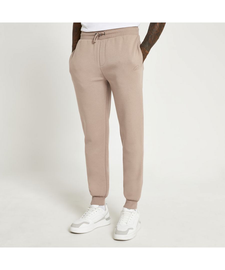 > Brand: River Island> Department: Men> Material: Polyester> Material Composition: 59% Polyester 41% Cotton> Type: Tracksuit> Style: Jogger> Size Type: Regular> Fit: Slim> Closure: Drawstring> Leg Style: Straight> Pattern: No Pattern> Occasion: Casual> Selection: Menswear> Season: AW21