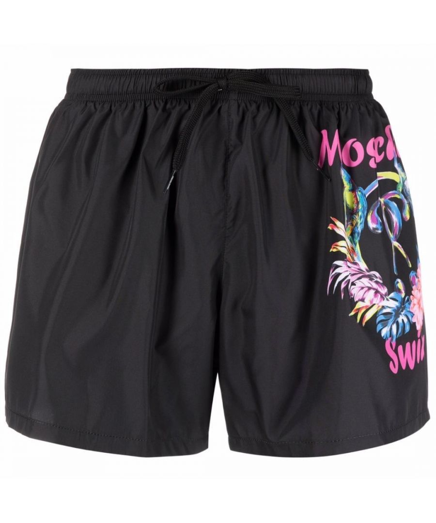 Moschino Large Floral Logo Black Shorts. Moschino Black Shorts. Elasticated Waistband, Drawstrings. 100% Polyester, Swim Shorts. Moschino Swim Face Design On Front With Flower Design. Product Code - A6113 5603 0555