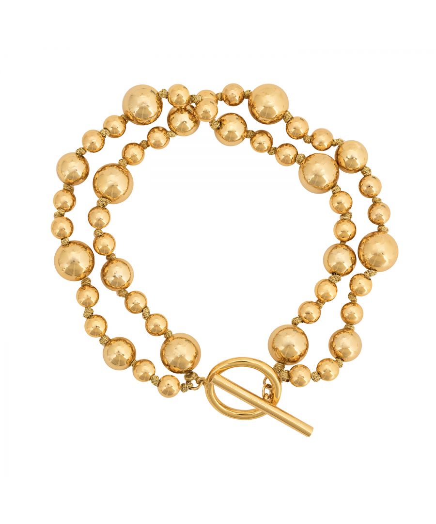Our Kate Thornton Gold Artisan Ball bracelet is simple and glamorous! An elegant gold plated ball bracelet comprising of 2 layers of shiny balls that will adds a touch of glamour to your look. Pair with the matching necklace and earrings for a complete set. Bracelet length 19.5cm with a hoop and bar fastening. Presented in a Ktx jewellery pouch to keep safe or make the perfect gift!
