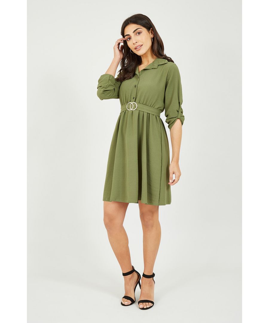Keep it classic with this Mela Khaki Circle Ring Belted Shirt Dress. Features a button through fastening and shirt style collar, this dress cinches your waist with an iconic gold buckle belt and features bow tie detailing to the back. Match with gold accessories and ankle boots or strappy heels for day-to-night chic.