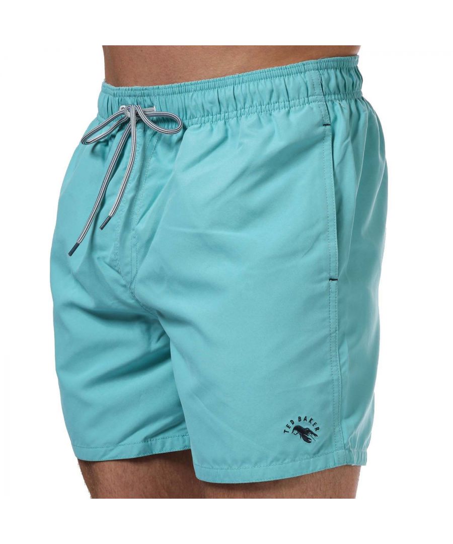 Mens Ted Baker Seafish Plain Swim Shorts in turquois.- Elasticated drawcord waist.- Two slip pockets.- Mesh inner brief.- Ted Baker branding.- Shell: 100% Polyester. Lining: 100% Polyester.- Ref: 247616TURQUOIS