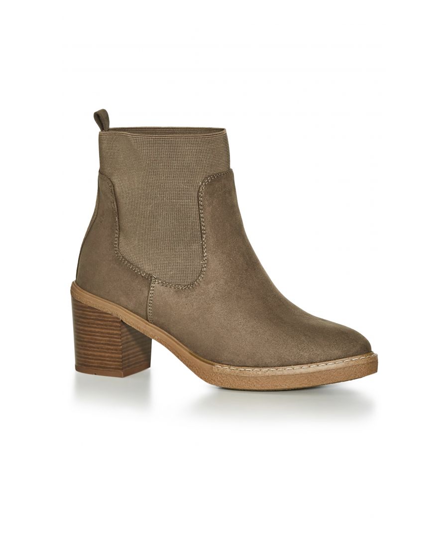 Trending in brown, the Brooke Ankle Boot is this season's must-have style. Featuring an extra wide fit and elastic contrast, these faux suede boots pair perfectly with light wash denim & neutral hues. Key Features Include: - Round toe - Extra wide fit - Slip on style - Elastic contrast - Wood stacked block heel - Faux suede fabrication