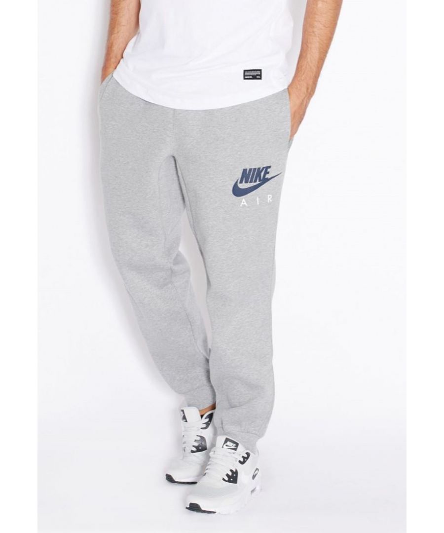 Nike Mens Fleece Joggers in Grey.     \nNike Air Signature Branding Print.     \nRich Cotton Blend Fabric with Warm Fleece Lining.     \nElasticated Waist with Adjustable Self-tie Drawstrings, Ribbed Cuffs.     \nTwo Side Slide-in and Single Wallet Pocket.