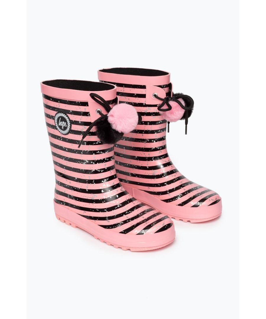 Slip on a pair of HYPE. wellies and you're literally ready for anything. Trentural rain? Covered. Sledging with the girls? Covered. New Black and Pink Stripe Wellies? Added to Bag. The HYPE. Black Pink Stripes Kids Wellies feature a 100% rubber fabric for the ultimate secured base. These juniors' wellies feature a pink and black colour palette in an all-over stripe and metallic speckle print. With a tie pom pom attachment. Finished with a puller and the iconic HYPE. crest monochrome logo. Wipe/Rinse clean.