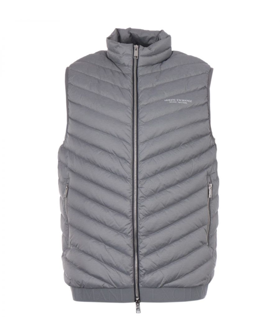 The perfect combination of urban aesthetics with contemporary styling, the Armani Exchange packable down gilet provides supreme warmth thanks to the genuine duck down padding and is crafted from super-lightweight durable nylon. Featuring a stand collar with a two-way zip closure, with zip pockets and elasticated trims. Finished with the Armani Exchange logo printed at the chest and an embossed logo hem. Regular Fit, Durable Lightweight Nylon, Genuine Duck Down & Feather Fill, Two-Way Zip Closure, Twin Front Zip Pockets, Elasticated Trims, Fully Packable, Armani Exchange Branding. Size & Fit: Regular Fit, Fits True to Size. Composition & Care: Shell: 100% Polyamide, Fill: 90% Duck Down & 10% Duck Feather, Machine Wash.