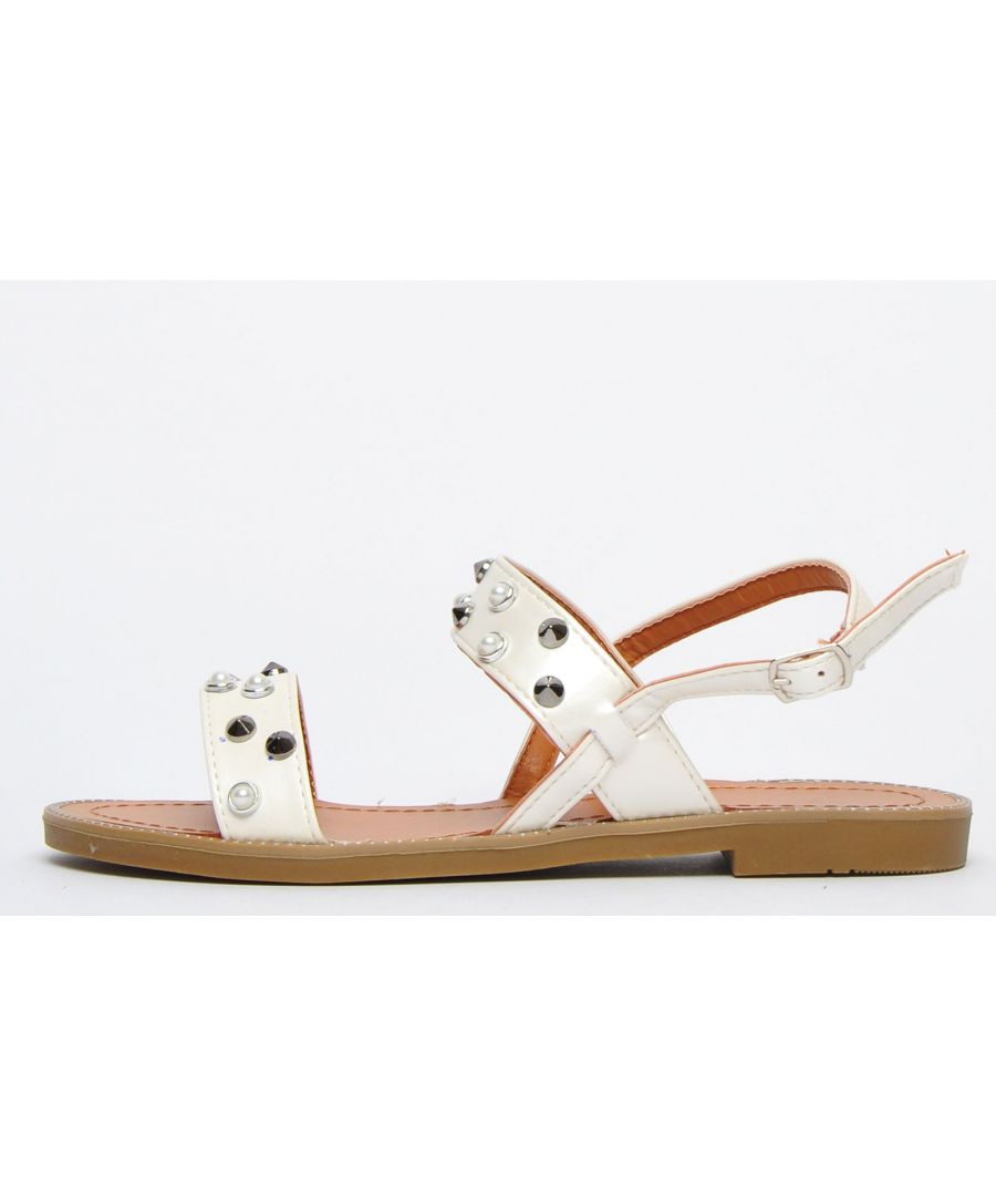 These eye-catching strappy Hadama sandals from Biscote Paris will infuse a glamorous twinkle to your summer day-to-day styling or special occasions alike.\n Featuring a double strap embellished finish with spike studs and pearls for a touch of glam with a slingback strap easily adjusted and secured with a buckle fastening paired with a contrasting diamante studded stitched outsole, this standout silhouette will effortlessly take centre stage of your warm-weather wardrobe.\n - Synthetic jewel upper\n - Adjustable buckle strap for a tailored fit\n - Stitched footbed\n - Grippy rubber outsole