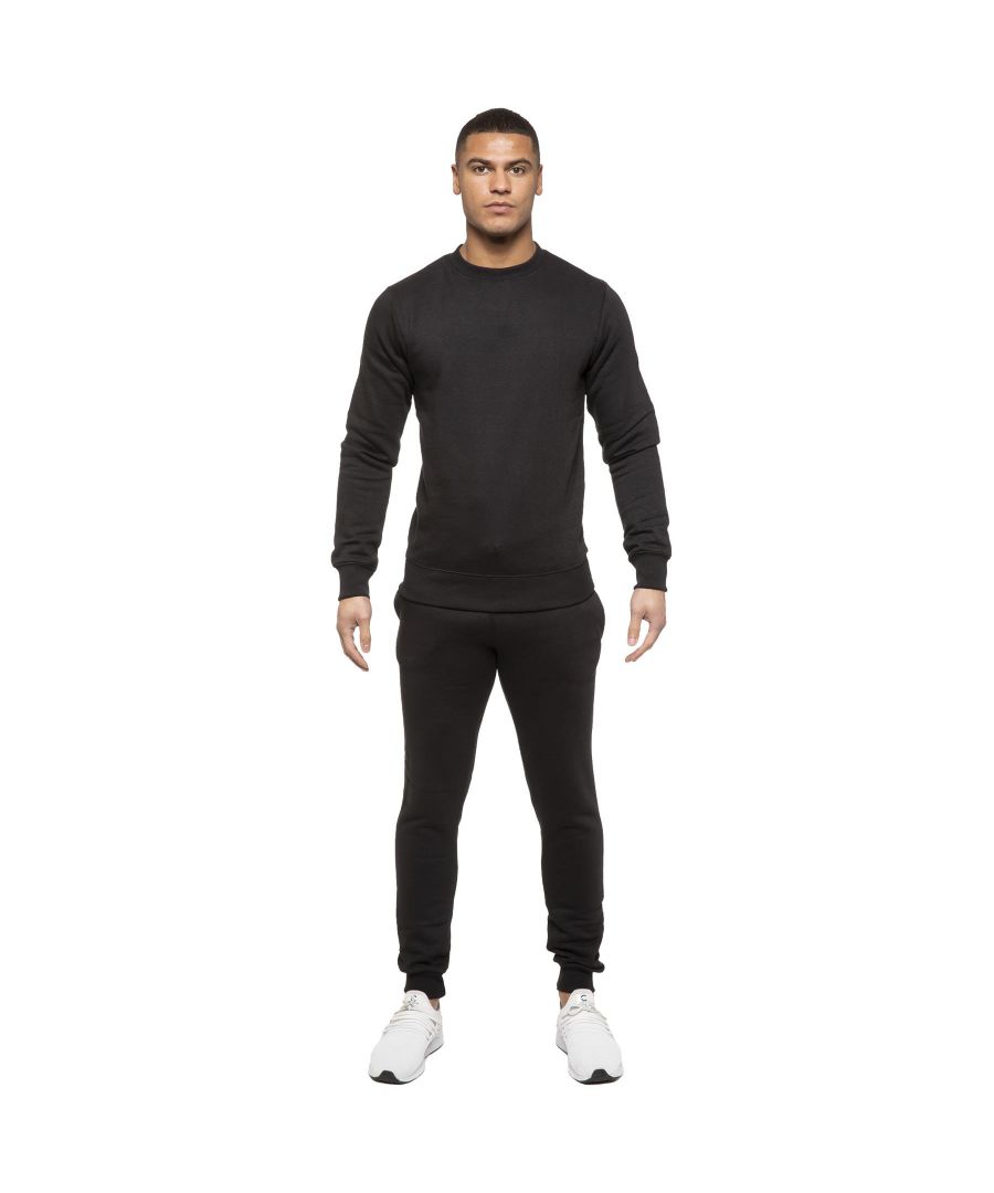 Kruze Mens Tracksuit set. Sweatshirt and Joggers set with 2 side Pockets, Drawstring, Ribbed Waist and Cuffs. Comfortable and Stylish. Inner lining of Brushed Back Fleece. Cotton Blend for Superior Quality. Crew Neck, Long Sleeves. Available in Black, Grey and Navy Colours. 52% Cotton, 48% Polyester. Machine Washable.