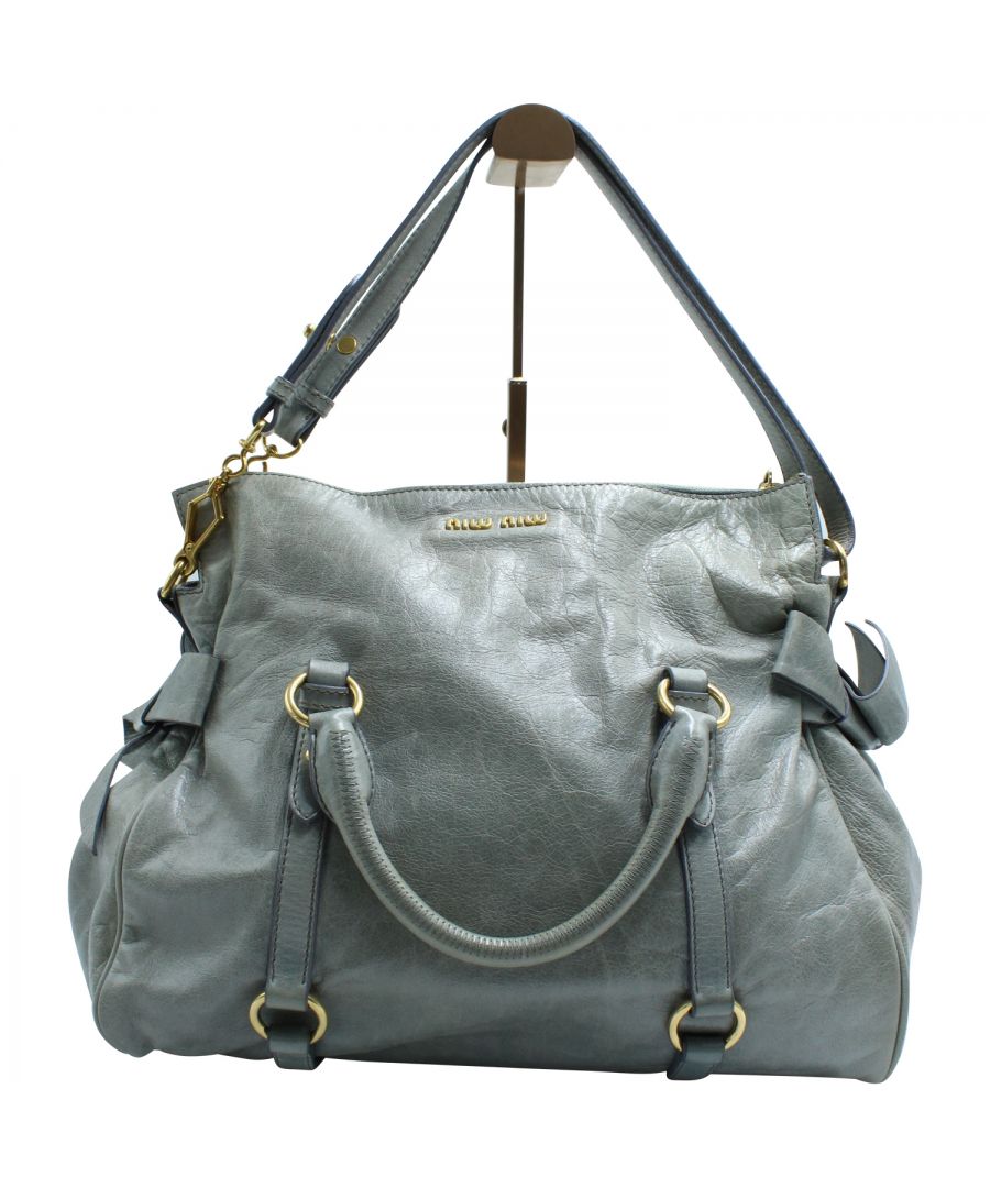 VINTAGE, RRP AS NEW\nMasterfully crafted from Vitello Lux leather and lined with satin, this satchel from the house of Miu Miu is both stylish and durable. In a rich shade of grey, it flaunts dual top handles and trendy bows detailed on the sides. Equipped with a detachable shoulder strap, it is the perfect versatile arm candy for your outfit goals!\n\n\nMiu Miu Vitello Lux Bow Satchel in Grey Leather\nColor: grey\nMaterial: Leather\nCondition: excellent\nSign of wear: light creases on outer leather\nSKU: 147460 / NAPBKGBBA107213W  \nSize: One size\nDimensions:  Length: 380 mm, Width: 170 mm, Height: 250 mm\nNote: It is in excellent condition.  Original receipt is available.