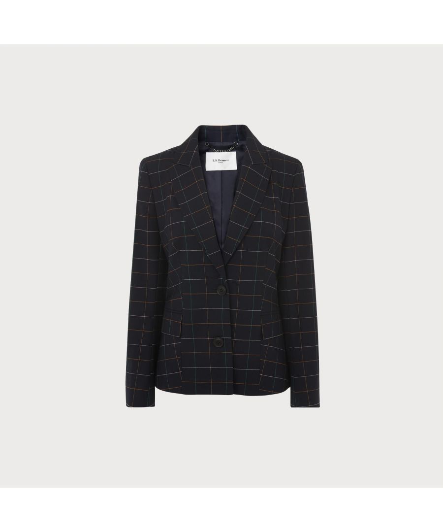 A beautiful piece of tailoring in our spring collection, the Leslie jacket works alone or as part of a suit. Crafted from a wool-blend suiting fabric in navy blue with a multi-coloured window pane check, it has a peak lapel, stab-stitch detail, flap pockets, chic covered buttons, a dusky pink lining and a single vent to the back. Wear it with the matching trousers for a stylish tailored spring look.