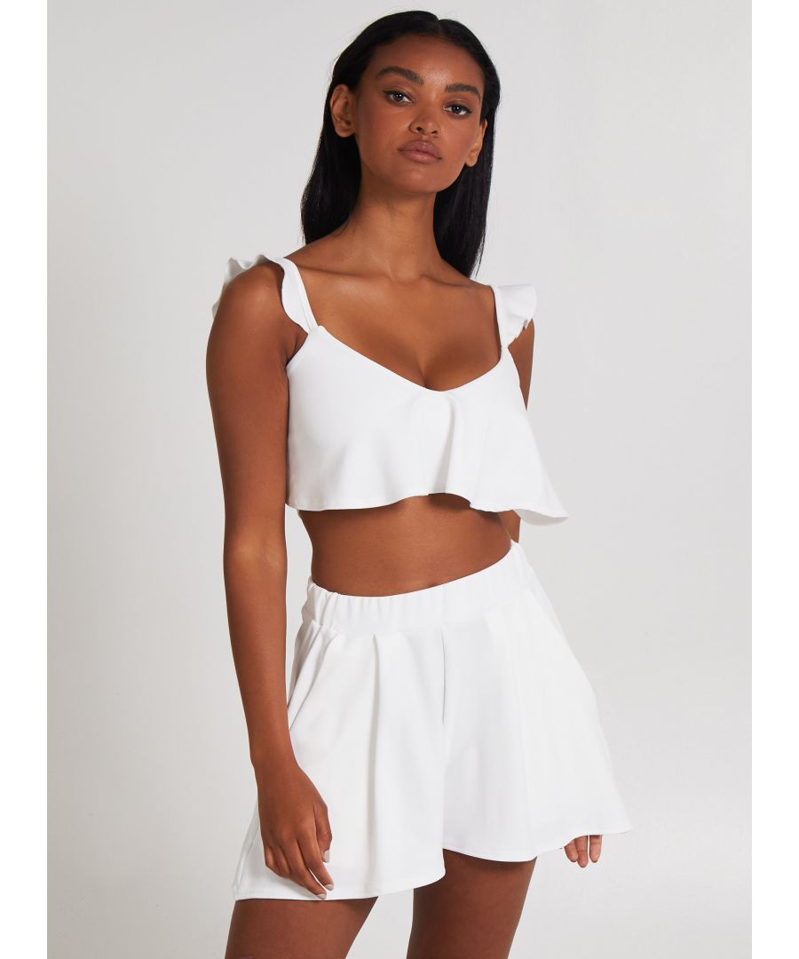 Get in the mood for love with this cute crop top. Featuring a frill design and strap. A must when paired with our POINT shorts. Composition: 95% Polyester, 5% Elastane. Wash Care: Machine Washable.