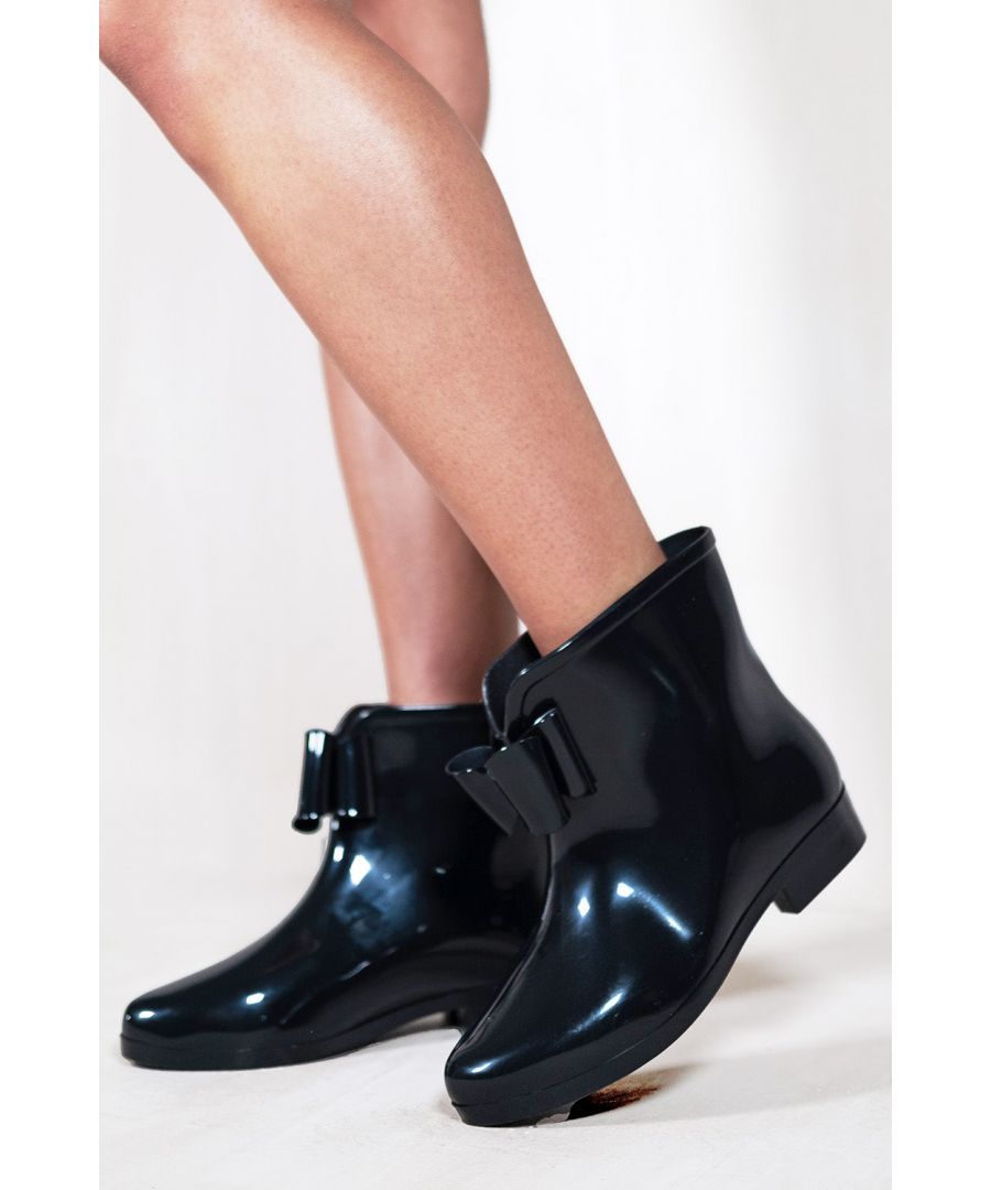 Women's patent ankle chelsea boot featuring a front bow