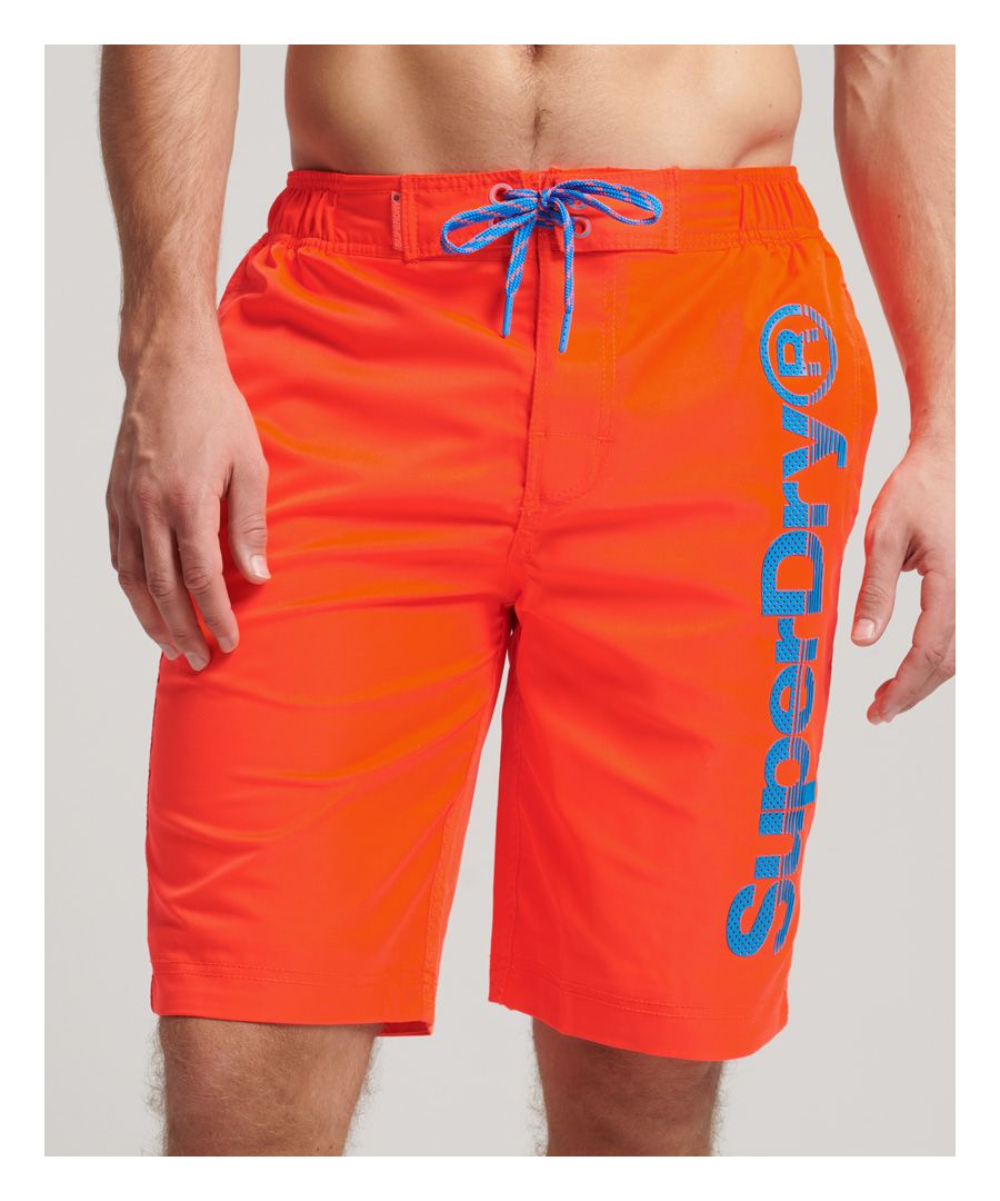 These swim shorts feature our iconic branding, ensuring that you can rock the Superdry look on land or at sea. Whether you're going to spend the day by the pool or are going to hit the coast, do it in a Superdry style.Elasticated drawcord waistbandHook and loop fasteningTwo side pocketsTextured print logo along left legMesh liningZip fastened pocket on back of right legRubber Superdry badge above back pocket