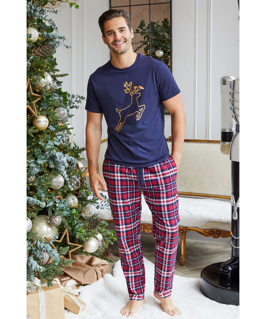 This cotton loungewear set from Threadbare has a short sleeve top with gold foil stag outline front print and check flannel bottoms with elasticated waist, drawcord and pockets. This set is super comfortable and perfect for lounging at home or bedtime.
