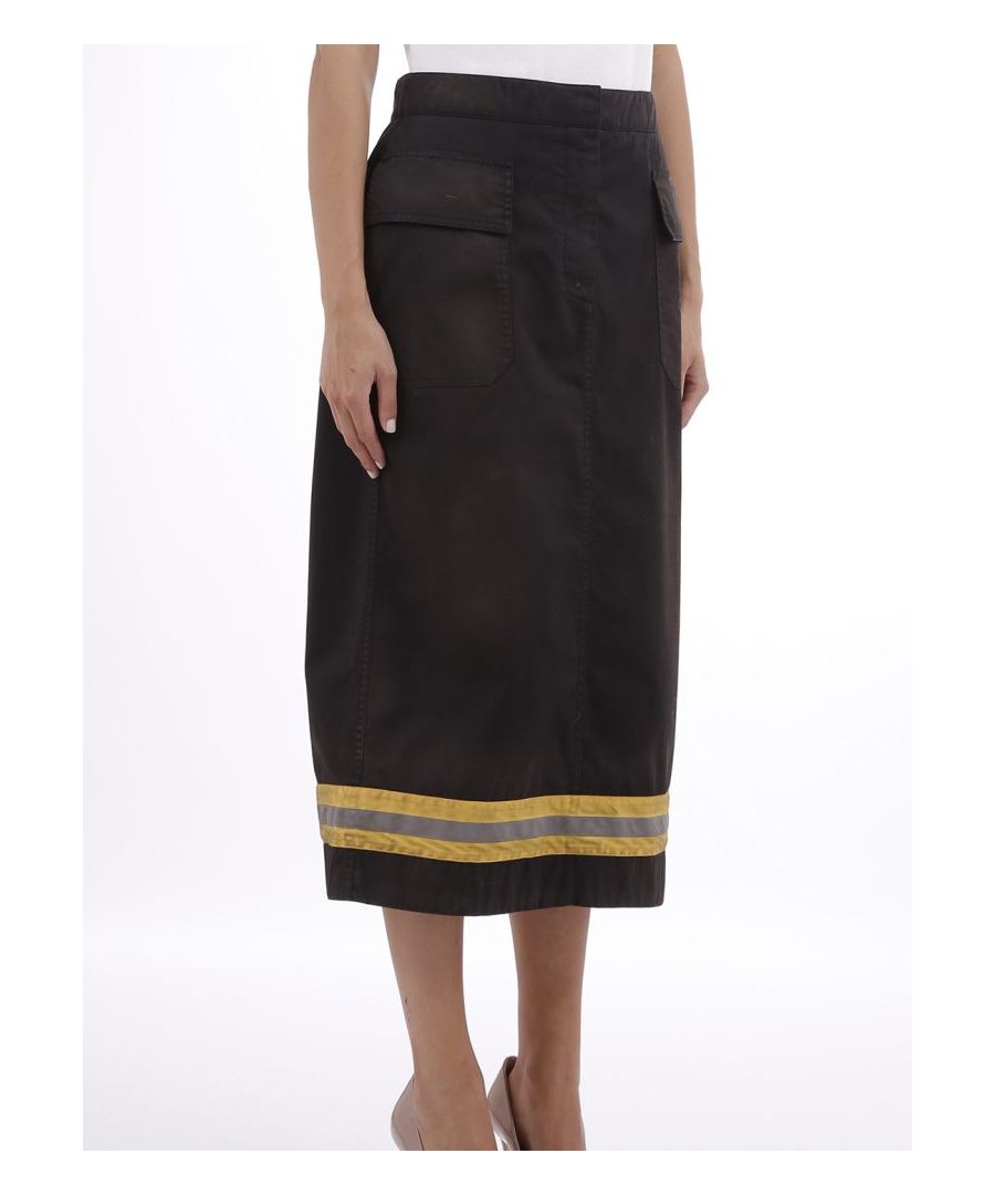 Black longuette skirt with flap pockets and concealed fastening on the front. From the clear reference to the uniforms of firemen, this skirt has a yellow band with a reflective band on the bottom.The model is 1,77 tall and wears size S / 40IT / 26US / 36FR / 8UK