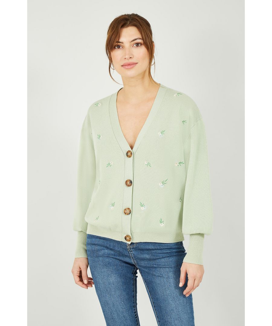 Brighten grey days with this super cute Yumi Soft Green Knitted Embroidered Daisy Cardigan. Perfect for layering, this cardigan features subtle vertical ribbing, gorgeous embroidered daisy detailing, close fit cuffs and baggy balloon style sleeves. Cut in a classic v-neck shape with large tortoiseshell button fastenings.