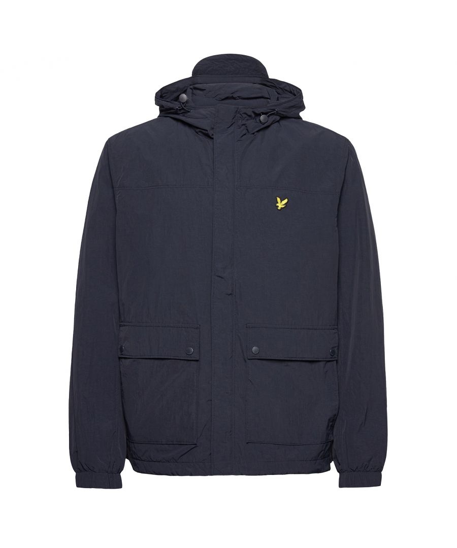 Mens Lyle And Scott Hooded Pocket Jacket in navy.- Adjustable grown-on hood.- Full zip fastening with press-stud storm flap.- Button-up front pockets.- Elasticated cuffs.- Signature Lyle & Scott Golden Eagle branding.- Bungee toggle adjustable hem.- Regular fit.- Outer: 100% Nylon. Body Lining: 100% Polyester. Sleeve Lininig: 100% Polyester.- Ref: JK1310VZ271