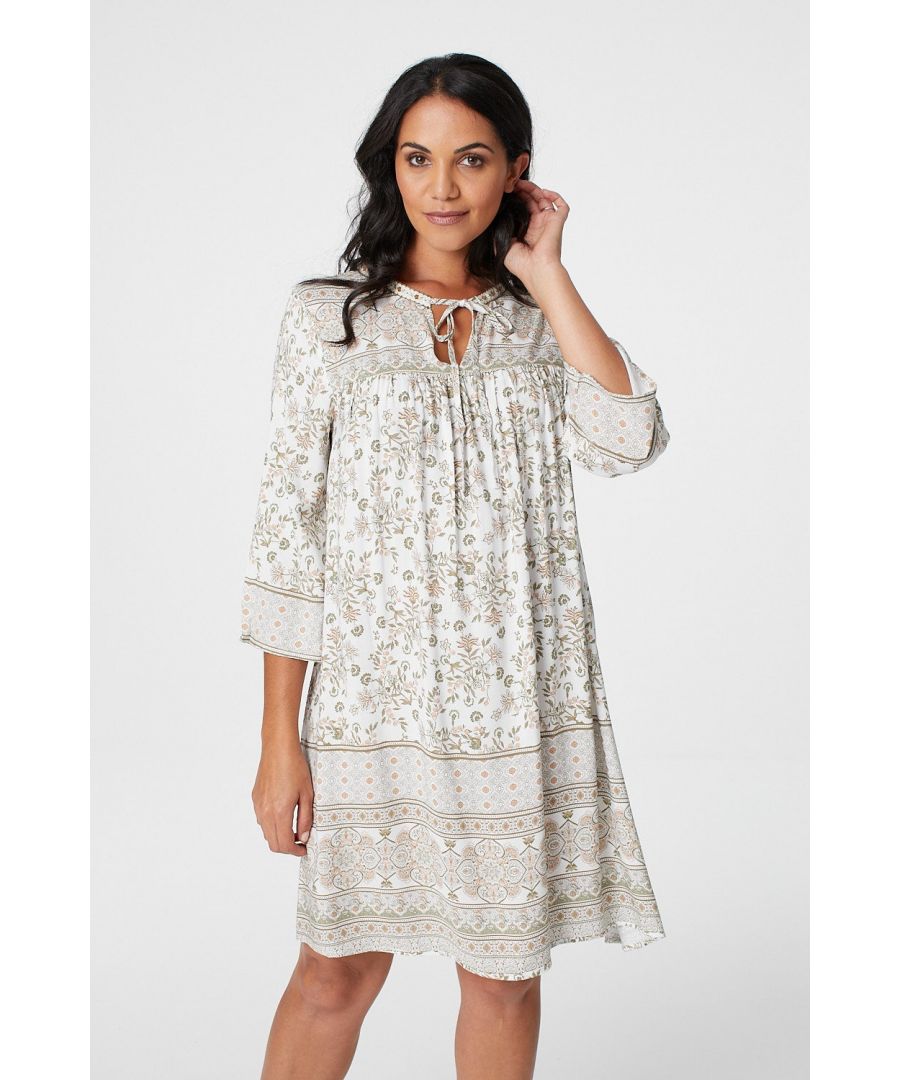 Add a vintage inspired floral smock dress to your collection with this border print tunic dress. With a round neck featuring a tie detail, 3/4 length sleeves, a relaxed fit and a short skirt. Dress up with heels or dress down with flat sandals.
