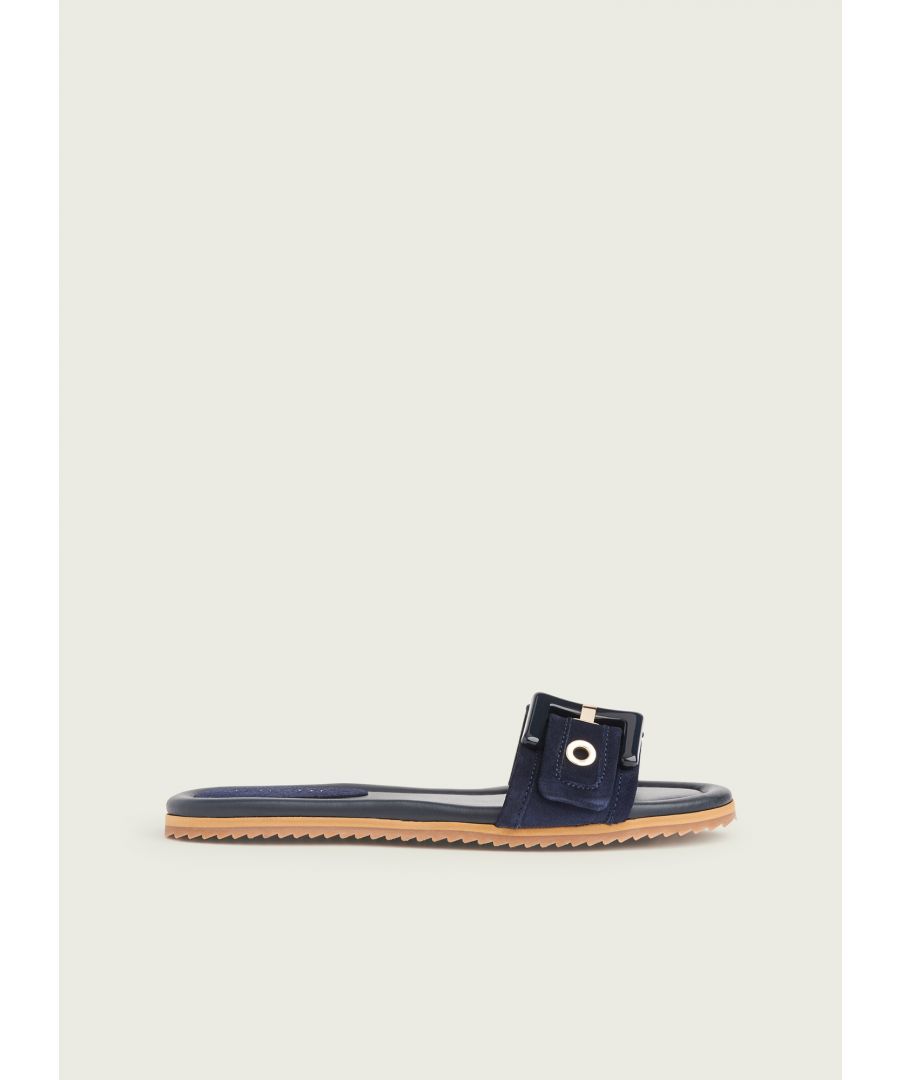 Our Robyn slip-on sandals are a stylish everyday style. Crafted in Spain from super-soft navy blue suede, they are a simple slip-on mule with blue buckle detail over the toes and a flat rubber sole. Wear them with your favourite summer dresses or a shorts and a tee.