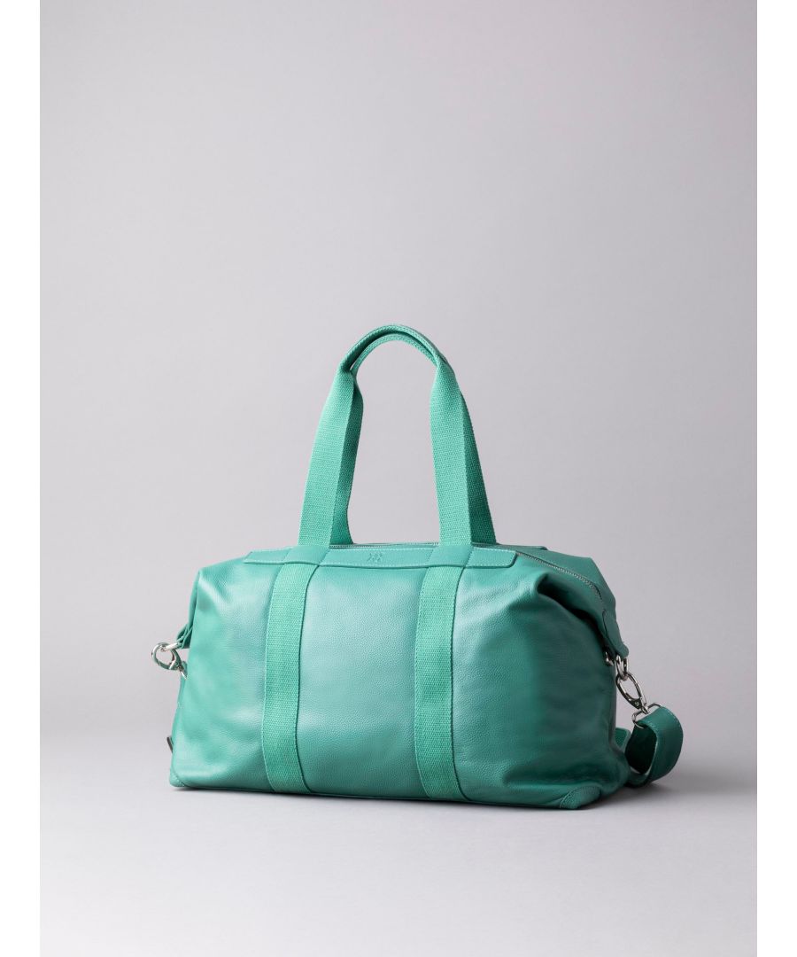 A sophisticated and softly structured leather holdall for those who love to travel in style. The Lorton Medium Leather Holdall is handcrafted in luxurious leather in a rich green colour. Its features include shoulder straps and an adjustable and detachable canvas strap for multiple ways to carry, and magnetic side studs to make your holdall more neat and compact once filled. The spacious interior lined with soft fabric contains handy zip and slip pockets to store your smaller valuables and the exterior features a rear zip pocket for quick access essentials.