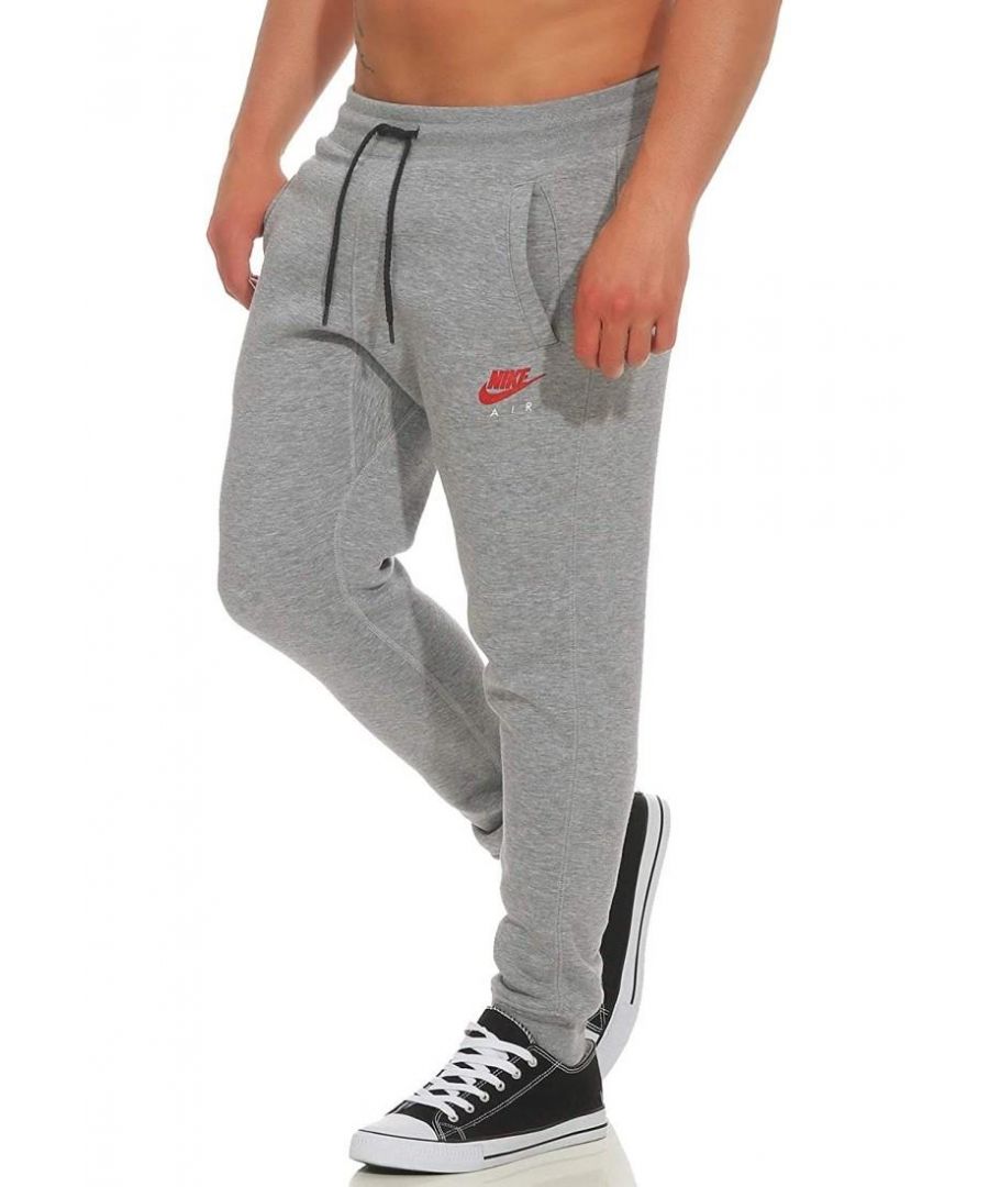 Nike Air Slim Fit Joggers Grey.    \nNike Air Logo Near Left Pocket.    \nTwo Side Pockets, Single Back Pocket.   \nSoft-brushed Fleece Lined Fabric.    \nElasticated Waist With Drawstring.  \nElasticated Hems.