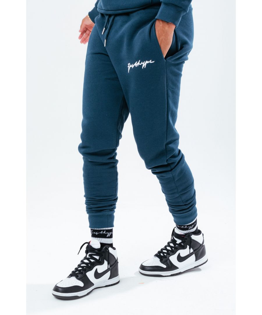 The HYPE. Men's Joggers boast a soft-touch fabric base ultimate amount of comfort, room and breathable space you need. With an elasticated waistband, drawstring pullers and fitted cuffs. The model wears a size M. Machine washable.