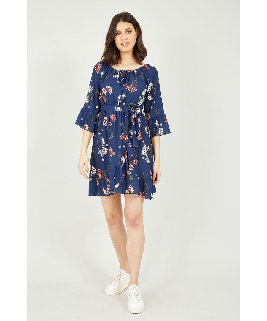 This Mela Bardot frill skater dress is the perfect every day dress for those sunny afternoons. The 3/4 sleeves embellished with a bell cuff and frill hem detail are flirty and add some interest to this easy wear piece. The skater shape has a tie waist and floral design, on a classic navy backdrop. The neckline is just off the shoulder and had a central cut out that can be tied. Add your favourite sandals, tan bag and top with a denim jacket.