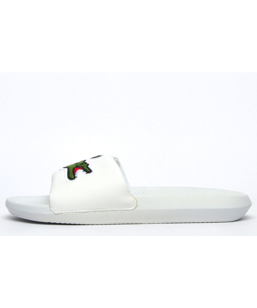 Step into eye catching summer style with these mens Croco Slides from Lacoste. In a bang on trend colourway, these designer sandals are delivered in a smooth synthetic upper with croc detailing across the forefoot foot strap. The comfy footbed moulds to your feet, delivering the perfect fit and feel while the grippy outsole will keep you sure and safe around the pool or in the shower. These designer slides are finished with eye catching Lacoste branding throughout just in case you want a sign of approval that youre wearing cool classic style this summer season \n - Comfort moulded footbed\n - Single strap detail over foot\n - Grippy outsole\n - Slip on wear\n - Iconic Lacoste branding throughout\n Please Note: These Lacoste Sliders are sold as B grades which means they have some slight cosmetic issues on the shoe and they come poly bagged. All shoes are guaranteed against fair wear and tear and offer a substantial saving against the normal high street price. The overall function or performance of the shoe will not be affected by cosmetic issues. B Grades are original authentic products released by the brand manufacturer with their approval at greatly reduced prices. If you are unhappy with your purchase we will be more than happy to take the shoes back from you and issue a full refund.