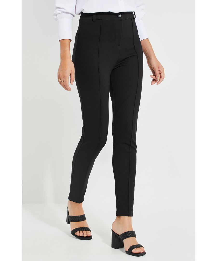 These tailored slim-fit trousers from Threadbare are perfect to take from day to night. The trousers feature button and zip fly fastening, High-waisted with belt loops and pin tuck details. Pair with a crisp shirt for workwear chic, and pair with a colour-pop blazer for after-work drinks. Other styles also available. Model Wears Size 8.