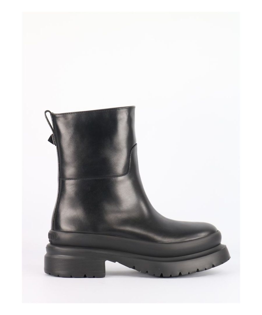 Roman Stud ankle boots in black calfskin. They feature pull tab on the back with maxi stud detail, Valentino Garavani logo on heel, rubber lug sole and round toe. Heel height: 5cm.