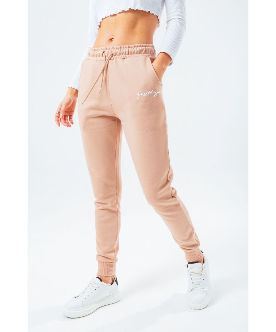 Joggers versatile for every occasion. The HYPE. Sand Women's Signature Joggers, available in UK size 4 up to 18, designed in 80% Cotton and 20% Polyester - the ultimate amount of comfort, room and breathable space you need. In our standard women's jogger shape, with an elasticated waistband, fitted cuffs and drawstring pullers. Finished with the new! justhype scribble logo. Check out the matching women's hoodies and t-shirts in the scribble range, perfect to mix 'n' match your day to night looks. Machine wash at 30 degrees.