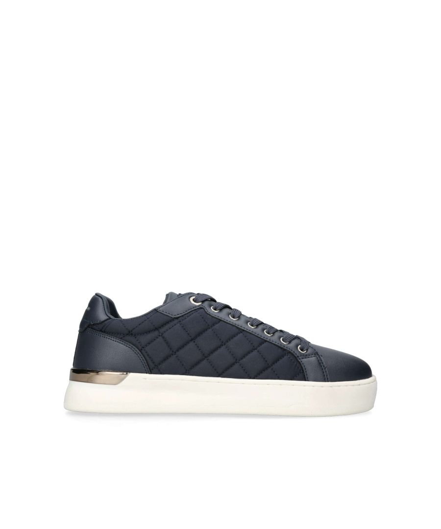 Keon Quilted from KG Kurt Geiger is a flat lace up trainer with a navy quilted upper and a gold panel at the heel of its' white sole.
