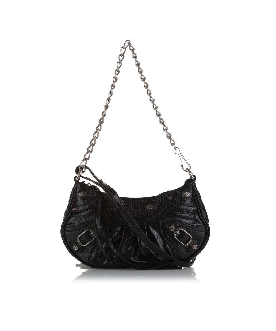 VINTAGE. RRP AS NEW. The Le Cagole features a leather body with giant studs, an adjustable flat leather strap, a removable chain strap, a top zip closure, and interior card slots.Exterior Front Worn. Exterior Back Worn. Exterior Bottom Worn. Exterior Handle Worn. Embellishment Scratched. Practical Attachment Scratched. \n\nDimensions:\nLength 13cm\nWidth 21cm\nDepth 5cm\nHand Drop 21cm\nShoulder Drop 52cm\n\nOriginal Accessories: Dust Bag\n\nColor: Black\nMaterial: Leather x Calf\nCountry of Origin: Italy\nBoutique Reference: SSU195729K1342\n\n\nProduct Rating: VeryGoodCondition\n\nCertificate of Authenticity is available upon request with no extra fee required. Please contact our customer service team.