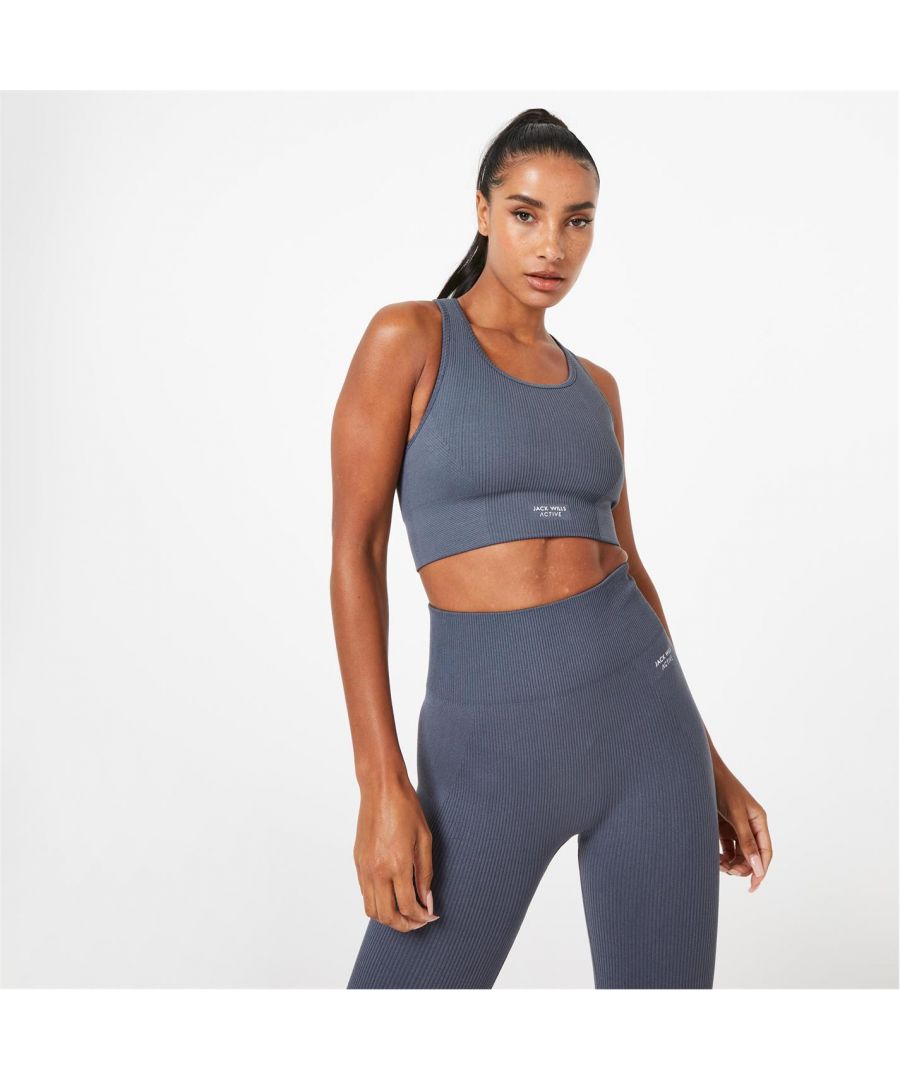 Jack Wills Active Seamless Ribbed Sports Bra - Sweat it out in style with the Active seamless sports bra. Featuring sweat wicking properties to keep you both cool and dry, the soft fabric will keep you feeling comfortable and confident throughout the day. Designed in a lovely length, which means you can rock it layered or solo. This stylish addition of the ribbed finish will make you want to keep it on outside of the gym too! Wear with the Jack Wills Active ribbed leggings to complete the effortless set. > Sweat wicking > Branding across chest > Thick straps > Crew neckline > Ribbed fabric > 92% Nylon, 8% Elastane > Machine washable > Underwire: Non Wired > Fastenings: Pull Over > Materials: Nylon > Adjustable Straps: No > Strap Type: Racerback Straps > Cup Style: Moulded > Care Instructions: Follow Care Instructions