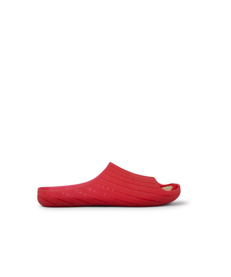 Red monomaterial slip-on men's sandals with 100% TPU outsoles (20% recycled) and removable natural tatami footbed. Fully recyclable. \n\nOriginally created to reduce materials and eliminate complex production processes, our iconic Wabi represents our decades-long push toward becoming more sustainable and circular.