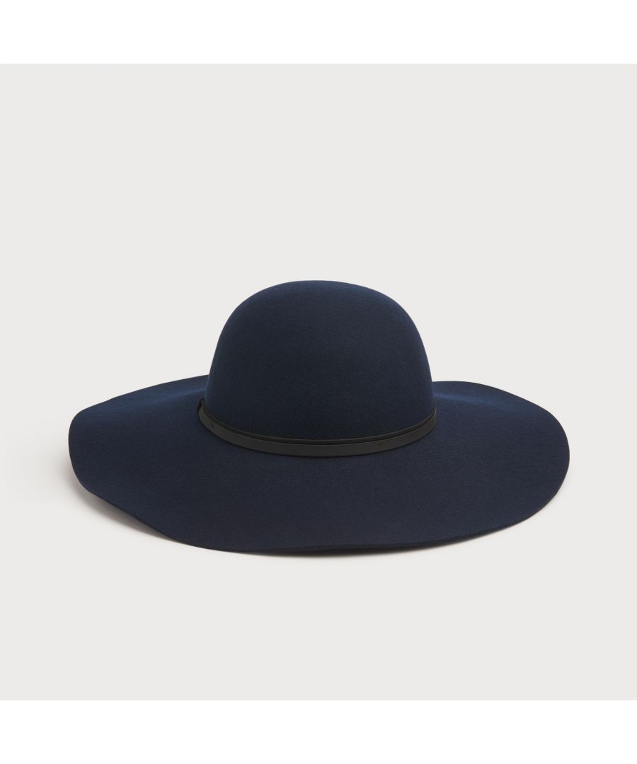 Kendall hat is crafted from classic navy blue wool and has the signature rounded crown, wide, floppy brim and is finished with a stylish black belt-style trim