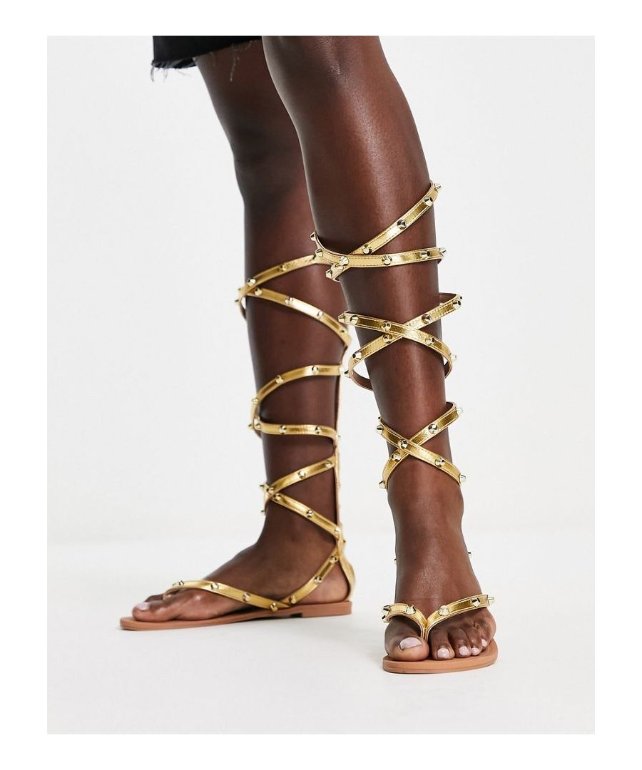 Sandals by ASOS DESIGN Love at first scroll Gladiator design Studded embellishment Zip-back fastening Toe post Flat sole  Sold By: Asos
