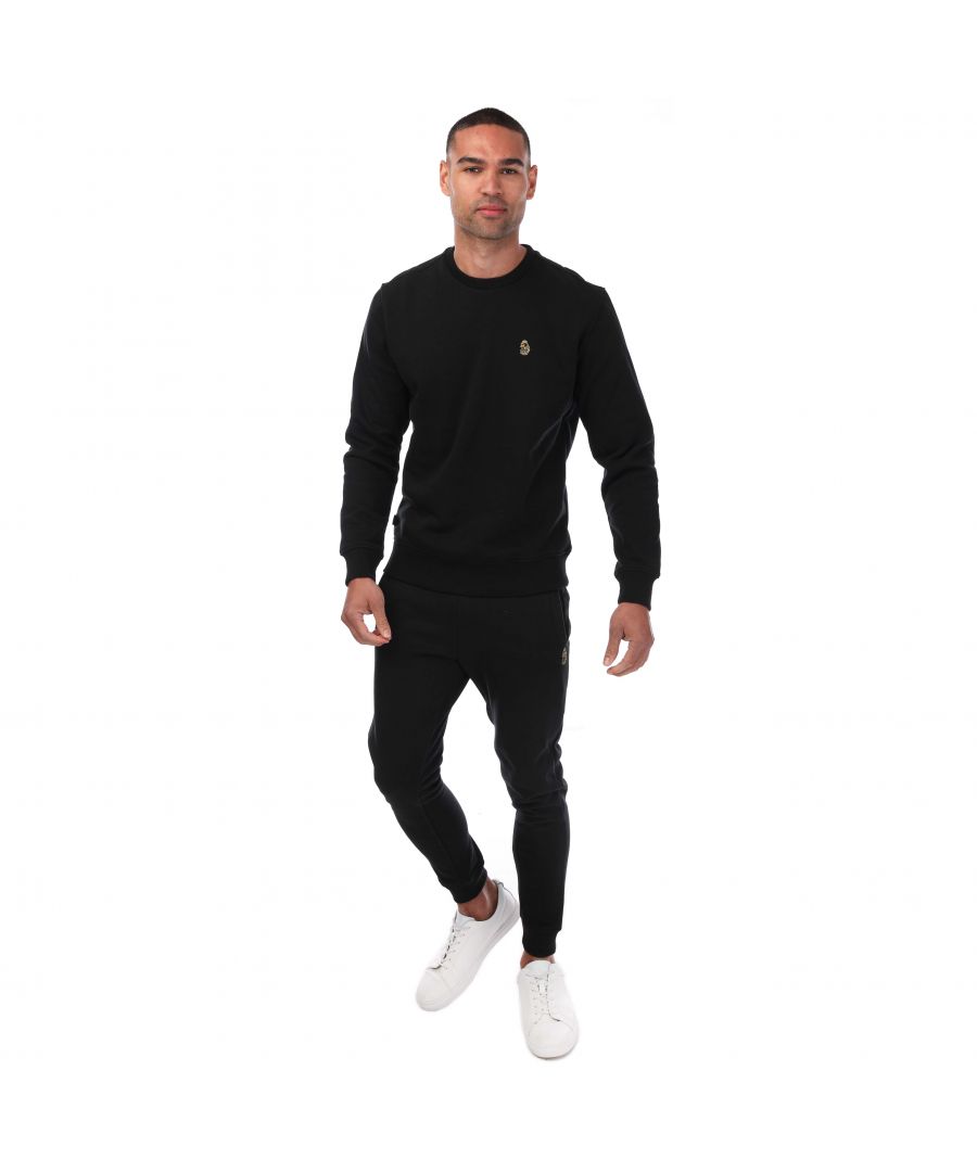Mens Luke 1977 The Runner Tracksuit in black. - Sweatshirt:- Ribbed crew neck.- Ribbed cuffs and hem.- Cotton fleece back fabrication.- Luke lion embroidery on chest.- 60% Cotton  40% Polyester. - Pants:- Drawstring waist.- Ribbed cuffs.- Two front pockets. - One back pocket with snap closure.- Luke 1977 logo embroidered at left thigh.- Regular fit.- 60% Cotton  40% Polyester.- Ref: M320313GSET