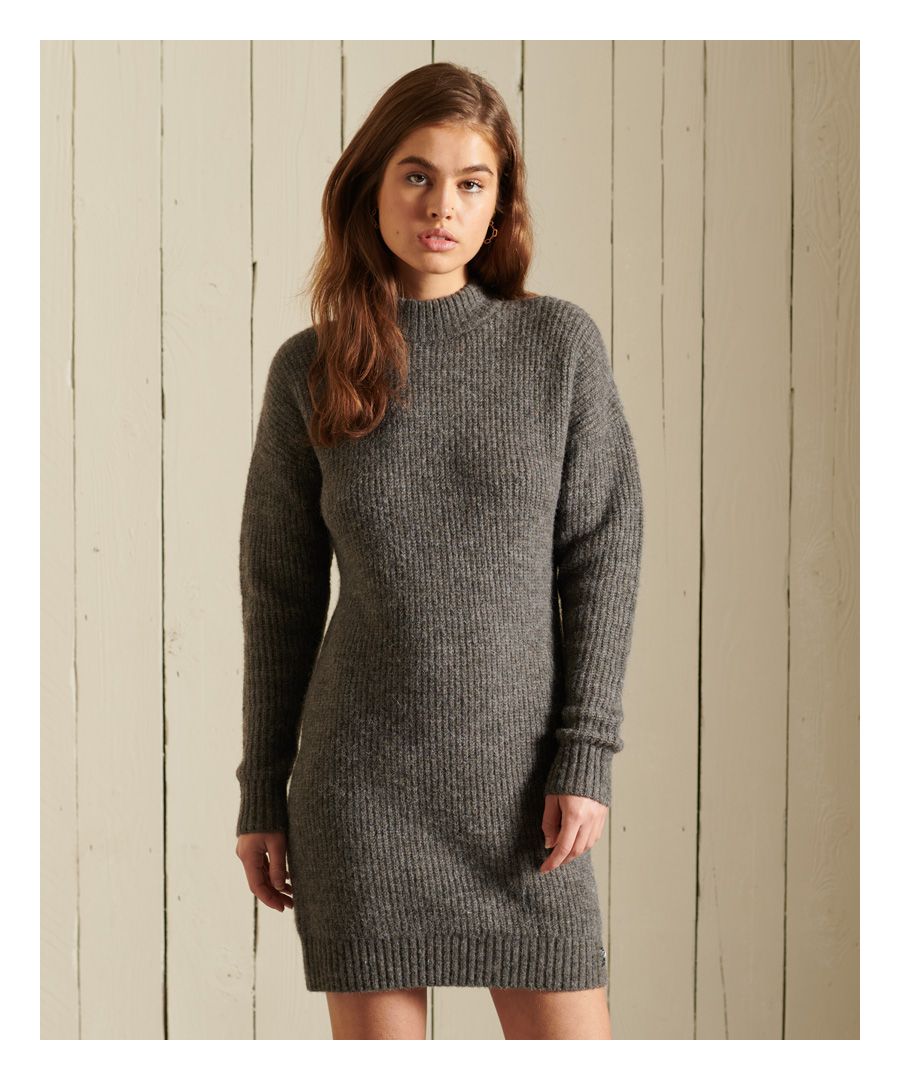 Feel effortlessly chic while you wrap up with our Alpaca Blend Knitted Dress. We're elevating the timeless knitted dress with an alpaca blend to provide authentic knitted textures. The silhouette combines fashion and comfort, ensuring you feel your best.Relaxed fit – the classic Superdry fit. Not too slim, not too loose, just right. Go for your normal sizeAlpaca blendKnitted designDropped shouldersRibbed neck, cuffs and hemSignature Superdry logo patch