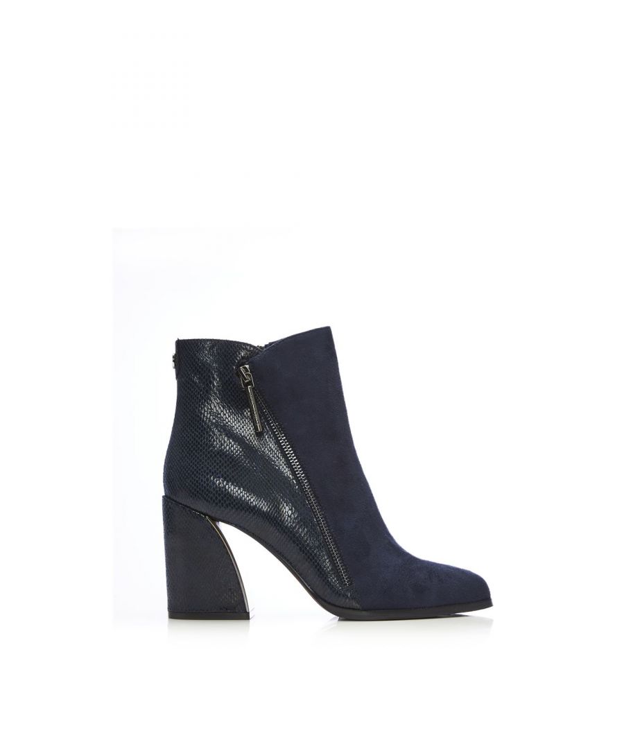 Your new favourite wide fit boot. Amy features a stunning curved block heel with a metallic inner, the contrasting textures on the shoe add further detail whilst still leaving it effortless to style. Complete with a functional inside zip and a decorative outside zip. Style with leather trousers and a blouse.